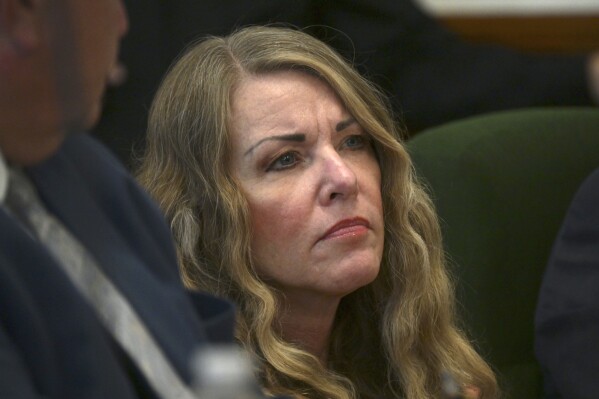 FILE - Lori Vallow Daybell sits during her sentencing hearing at the Fremont County Courthouse in St. Anthony, Idaho, July 31, 2023. On Wednesday, Oct., 25, 2023, an extradition warrant signed by Idaho Gov. Brad Little was delivered to other state officials, allowing Arizona officials to temporarily take custody of Daybell so she can face charges of conspiring to kill her estranged husband as well as her niece's ex-husband. (Tony Blakeslee EastIdahoNews.com via AP, Pool, File)