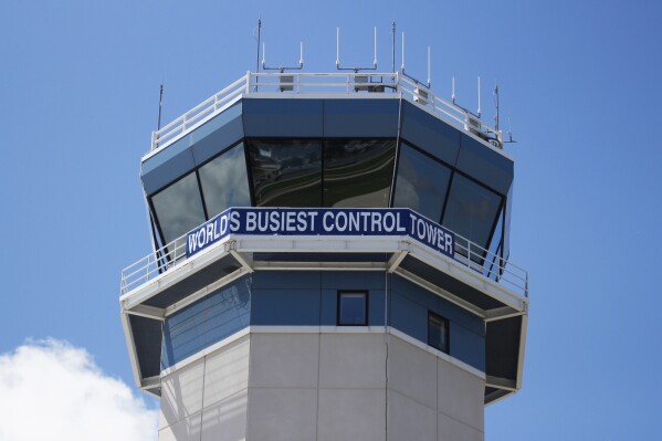 FILE - The control tower sits above the Wittman Regional Airport in Oshkosh, Wis. The daughter of a Super Bowl-winning former NFL player and her co-pilot are among the four people who died last weekend in two separate crashes at the annual Airventure convention which takes place annually at the Wittman Regional Airport. (AP Photo/Carrie Antlfinger, File)