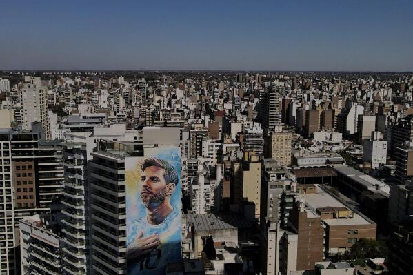 FILE - A mural of soccer player Lionel Messi blankets the facade of an apartment building in Rosario, Argentina, Aug. 19, 2022. Gunmen threatened Messi in a written message left March 2, 2023 when they opened fire at a supermarket owned by his in-laws in Rosario, Argentina, police said. (AP Photo/Natacha Pisarenko, File)