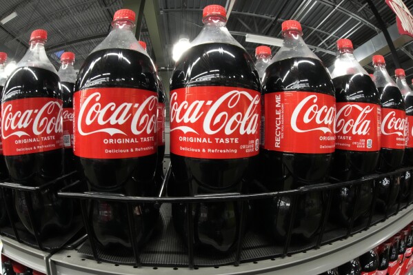 FILE - Bottles of Coca Cola are shown in a market in Pittsburgh on Jan. 26, 2023. Coca Cola reports results on Tuesday, Feb. 13, 2024. (AP Photo/Gene J. Puskar)
