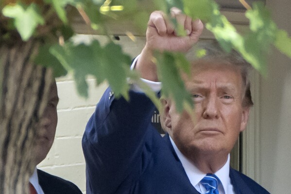 Republican presidential candidate former President Donald Trump gestures to supporters as he arrives for a visit to the offices of Safari Club International after meeting with Republican senators at the National Republican Senatorial Committee, Thursday, June 13, 2024, in Washington. (AP Photo/Mark Schiefelbein)
