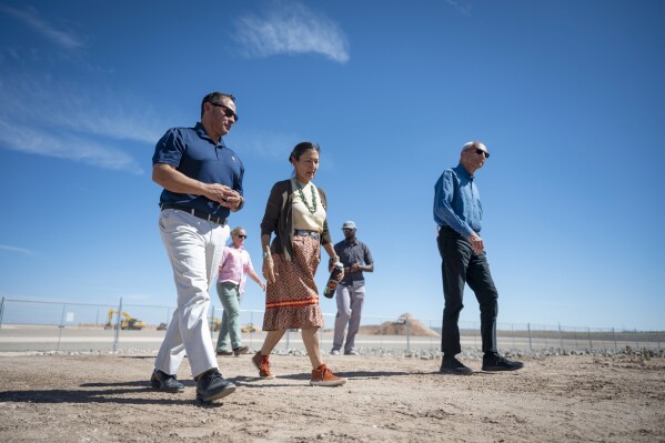 N.M. Lt. Governor Howie Morales, left, walks with Secretary of the Interior Deb Haaland, center and Clean Energy Advisor to the White House John Podesta, right, during a ground breaking ceremony for the SunZia transmission line project in Corona, N.M., on Friday, Sept. 1, 2023. An energy infrastructure project bigger than the Hoover Dam is how Hunter Armistead describes the $10 billion venture his company will be overseeing during the next three years. (Jon Austria/The Albuquerque Journal via AP)