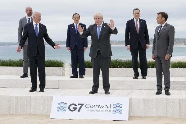 President Joe Biden and British Prime Minister Boris Johnson gesture as they pose for a family photo with G-7 leaders in Carbis Bay, England, Friday, June 11, 2021. Leaders from left, European Council President Charles Michel, Biden, Japan's Prime Minister Yoshihide Suga, Johnson, Italy's Prime Minister Mario Draghi and French President Emmanuel Macron. (AP Photo/Patrick Semansky, Pool)