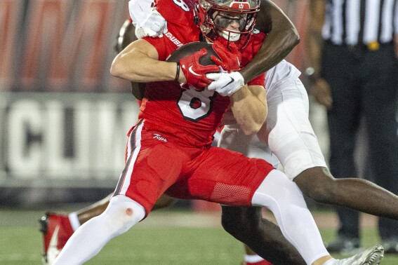 Western Kentucky wide receiver Easton Messer (8) is tackled by Middle Tennessee State cornerback De'Arre McDonald (28) during the first half of an NCAA college football game Thursday, Sept. 28, 2023, in Bowling Green, Ky. (Joe Imel/Daily News via AP)