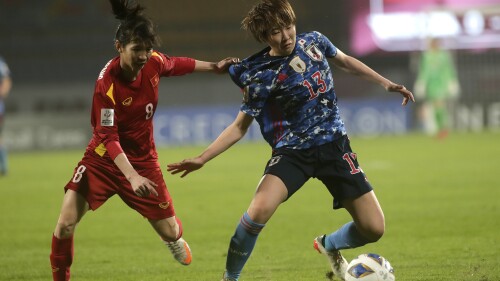 FILE - Japan's Jun Endo, right, and Vietnam's T.T. Tran Thi fight for the ball during the AFC Women's Asian Cup 2022 match between Japan and Vietnam in Pune, India, Monday, Jan. 24, 2022. (AP Photo/Emmanual Yogini, File)