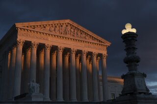 FILE - In this Jan. 24, 2019, file photo, the Supreme Court is seen at sunset in Washington. The Supreme Court is preventing the Trump administration from re-starting federal executions next week after a 16-year break. The court on Friday, Dec. 6, denied the administration's plea to undo a lower court ruling in favor of inmates who have been given execution dates. (AP Photo/J. Scott Applewhite, File)