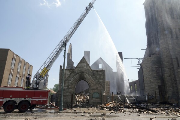 Firefighters douse the historic Clayborn Temple, a landmark from the civil rights movement with ties to Martin Luther King Jr., with water after it caught fire, April 28, 2025, in Memphis, Tenn. (AP Photo/Karen Pulfer Focht, File)
