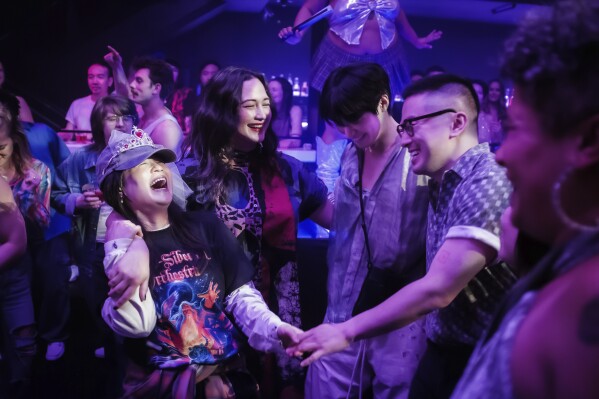 This image released by Bleecker Street shows Kelly Marie Tran, from left, Lily Gladstone, Han Gi-Chan and Bowen Yang in a scene from "The Wedding Banquet." (Bleecker Street via AP)