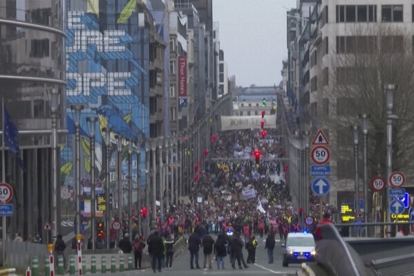 In this grab taken from video, climate activists take part in a march, in Brussels, Sunday, Dec. 3, 2023. Thousands of people have marched through the center of Brussels in a boisterous rally highlighting the dangers of climate change, as the COP28 climate summit draws to an end in the United Arab Emirates. (AP)