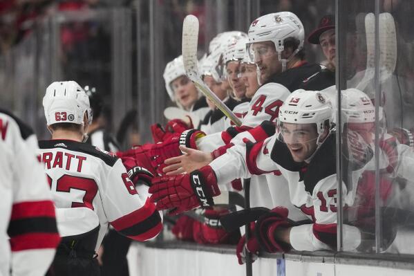 New Jersey Devils left wing Jesper Bratt (63) is greeted by teammates after scoring during the second period of an NHL hockey game against the Anaheim Ducks in Anaheim, Calif., Friday, Jan. 13, 2023. (AP Photo/Ashley Landis)