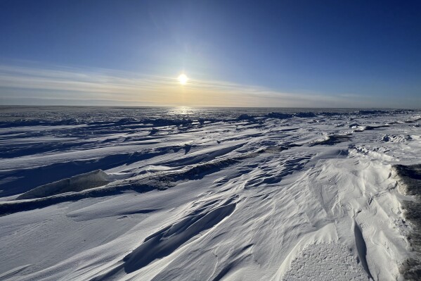 FILE - The sun sets outside of the northwest Alaska village of Point Hope on the Chukchi Sea, Feb. 21, 2024. An arraignment is scheduled Friday, March 8, 2024, for Guy Nashookpuk, a 16-year-old charged as an adult in the shooting deaths of two people in the remote Alaska whaling village of Point Hope. (Ka'ainoa Ravey via AP, File)