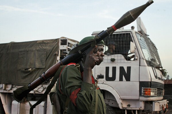FILE - A Congolese government soldier (FARDC) stands guard by a UN truck at the Kibati checkpoint north of Goma, eastern Congo, on Nov. 23, 2008. The United Nations Peacekeeping efforts is under resourced as its $5.5 billion budget for worldwide operations is less than the New York Police Department's $6.1 billion budget, even though it has 30,000 more personnel, the UN Under-Secretary General, Peace Operations Jean-Pierre Lacroix said Wednesday, Dec. 6, 2023 at a two-day UN Peacekeeping Ministerial Meeting in Accra, Ghana. (AP Photo/Jerome Delay, File)