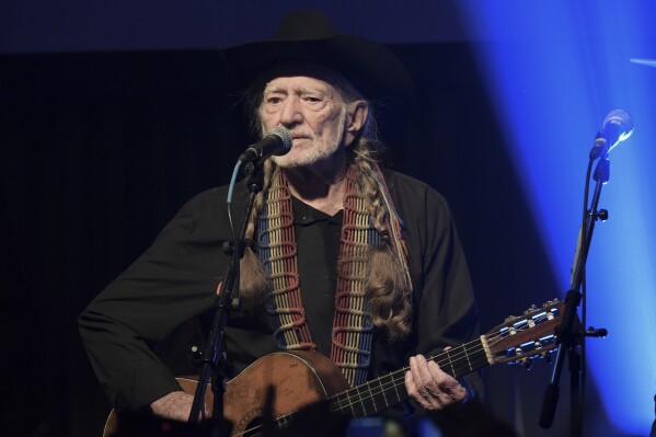 FILE - Willie Nelson performs at the Producers & Engineers Wing 12th Annual GRAMMY Week Celebration in Los Angeles on Feb. 6, 2019. The country legend's new book, “Energy Follows Thought,” gives the stories behind his most famous songs. (Photo by Richard Shotwell/Invision/AP, File)