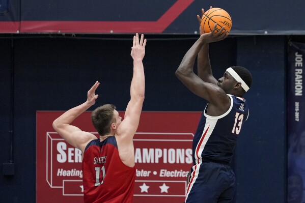 Gonzaga forward Graham Ike (13) shoots over Saint Mary's center Mitchell Saxen (11) during the first half of an NCAA college basketball game Saturday, March 2, 2024, in Moraga, Calif. (AP Photo/Godofredo A. Vásquez)