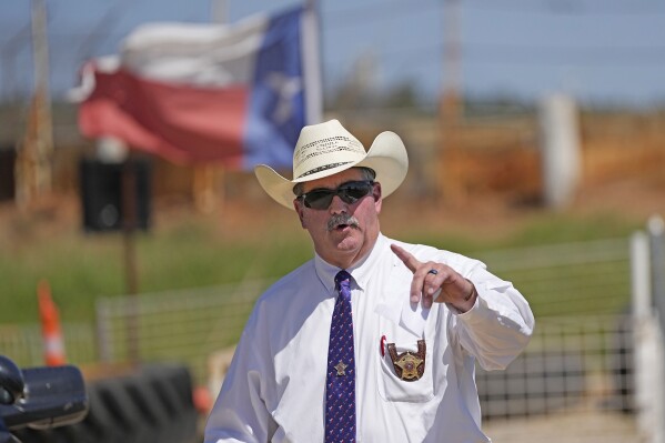 FILE - San Jacinto County Sheriff Greg Capers answers a question after a news conference, Sunday, April 30, 2023, in Cleveland, Texas. Capers’ turn in the national spotlight after an April mass shooting belied years of complaints about corruption and dysfunction that were previously unknown outside the piney woods of San Jacinto County. (AP Photo/David J. Phillip, File)