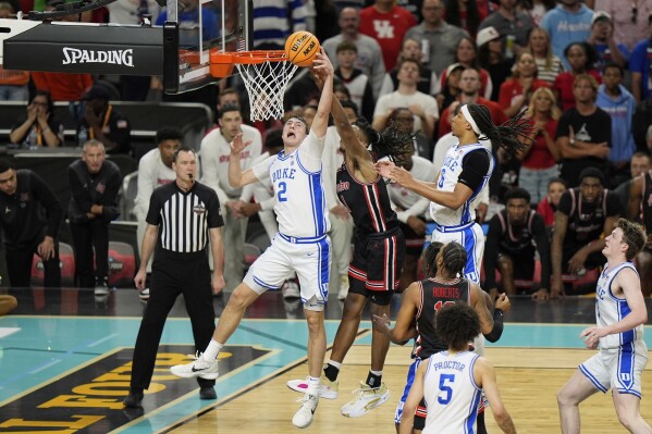 Duke's Cooper Flagg (2) shoots as Houston's Joseph Tugler (11) defends during the second half in the national semifinals at the Final Four of the NCAA college basketball tournament, Saturday, April 5, 2025, in San Antonio. (AP Photo/Stephanie Scarbrough)