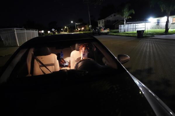 Jada Riley sits in her car at night with her son Jayden Harris, 6, as she contemplates where she might spend the night, having had to move out of her apartment a few days before, Thursday, July 28, 2022, in New Orleans. “I've slept outside for a whole year before. It's very depressing, I'm not going to lie,” said Riley, who often doesn't have enough money to buy gas or afford food every day. “I don't want to have my son experience any struggles that I went through.” (AP Photo/Gerald Herbert)