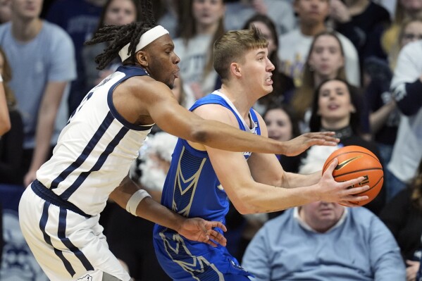 Creighton's Baylor Scheierman (55) goes to the basket against Butler's Augusto Cassia (0) during the first half of an NCAA college basketball game, Saturday, Feb. 17, 2024, in Indianapolis. (AP Photo/Darron Cummings)