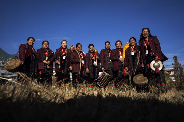 Band members of Shrijanshil Mahila Sanstha, or the Self-Reliant Women’s Group, stand for a photograph before they prepare to play at a wedding in Kathmandu, Nepal, Wednesday, March 6, 2024. Once associated only with men from the Damai community, part of the lowest caste, these nine women have come together to play the naumati baja, or nine traditional instruments. Discrimination based on caste is believed to have caused some Dalit musicians to quit playing naumati baja. (AP Photo/Niranjan Shrestha)