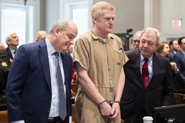FILE - Alex Murdaugh speaks with his legal team before he is sentenced to two consecutive life sentences for the murder of his wife and son by Judge Clifton Newman at the Colleton County Courthouse on Friday, March 3, 2023 in in Walterboro, S.C. Murdaugh's lawyers have filed court papers that he plans to plead guilty in federal court to charges he stole money from clients. (Joshua Boucher/The State via AP, File, Pool)