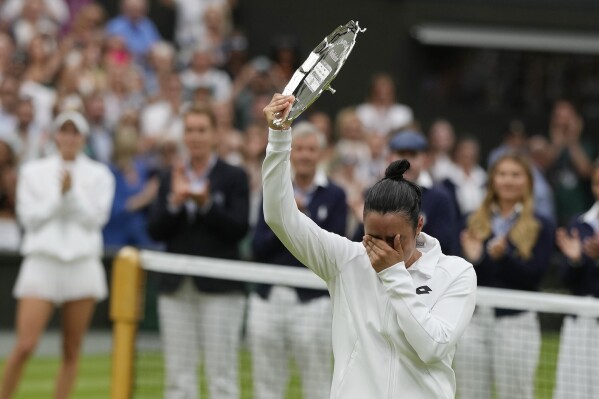Tunisia's Ons Jabeur with her runners up trophy after losing to Czech Republic's Marketa Vondrousova in the women's singles final on day thirteen of the Wimbledon tennis championships in London, Saturday, July 15, 2023. (AP Photo/Alastair Grant)