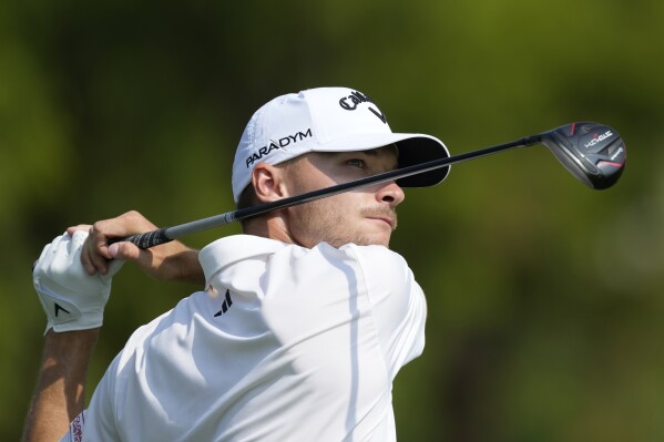 Nicolai Hojgaard of Denmark plays his second shot on the second hole hole during the final round of the DP World Tour Championship golf tournament, in Dubai, United Arab Emirates, Sunday, Nov. 19, 2023. (AP Photo/Kamran Jebreili)