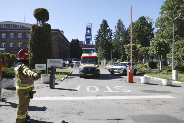 An ambulance is leaving the Myslowice-Wesola coal mine in Myslowice, southern Poland, Tuesday, May 14, 2024 where two miners were killed, one went missing and another 12 were injured in a cave-in near the coal face. (AP Photo/Kasia Zaremba-Majcher)