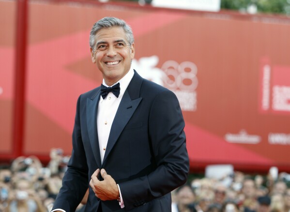 FILE - George Clooney poses on the red carpet at the premiere of his film "The Ides of March," opening the 68th edition of the Venice Film Festival in Venice, Italy on Aug. 31, 2011. (AP Photo/Andrew Medechini, File)