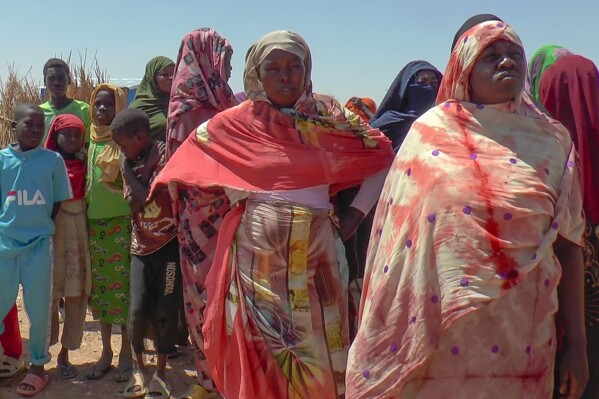 Sudanese refugees displaced by the conflict in Sudan gather to receive food staples from aid agencies at the Metche Camp in eastern Chad Tuesday, March 5, 2024. Overcrowded refugee camps in eastern Chad are set to run out of money soon, exacerbating a dire humanitarian crisis caused by the spillover from the war in Sudan, the United Nations said. (AP Photo/Jsarh Ngarndey Ulrish)