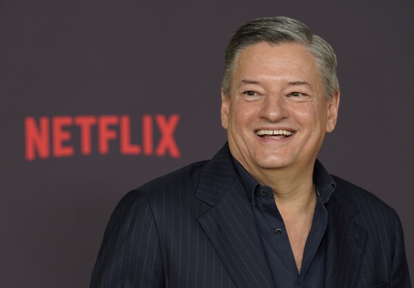 FILE - Netflix co-CEO Ted Sarandos poses at the Netflix film premiere "good sadness," On December 19, 2023 in Los Angeles.  The typical compensation package for CEOs who run companies in the S&P 500 jumped nearly 13% in 2023. (AP Photo/Chris Pizzello, File)