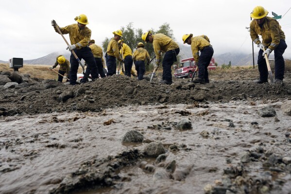 Members of Cal Fire Pilot Rock 6 crew, out of Crestline, Calif., clear mud off the side of the road in the aftermath of Tropical Storm Hilary, Monday, Aug. 21, 2023, in Yucaipa, Calif. Scientists figure a natural El Nino, human-caused climate change, a stubborn heat dome over the nation’s midsection and other factors cooked up Hilary’s record-breaking slosh into California and Nevada. (AP Photo/Marcio Jose Sanchez)