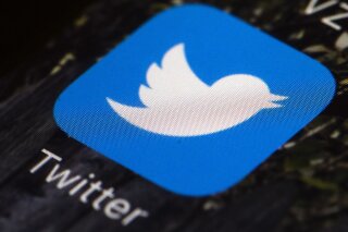 FILE - This April 26, 2017, file photo shows the Twitter app icon on a mobile phone in Philadelphia. Twitter announced Monday, May 11, 2020, it will warn users with a label when a tweet contains disputed or misleading information about the coronavirus. (AP Photo/Matt Rourke, File)