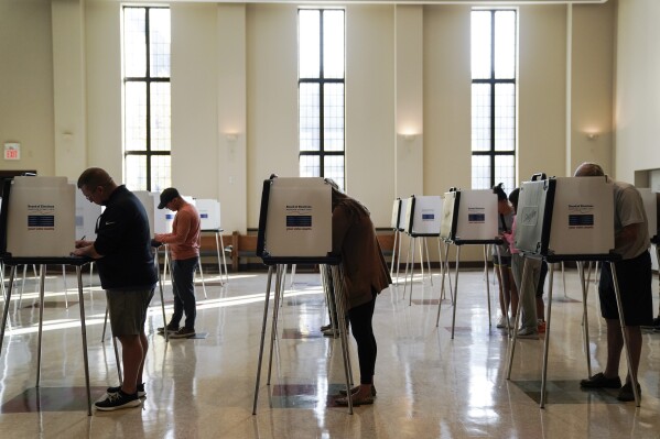 FILE - People vote on Election Day, Nov. 7, 2023, at Knox Presbyterian Church in Cincinnati. On Monday, Jan. 8, 2024, a federal judge upheld as constitutional provisions of the sweeping election law that Ohio put in place last year, rejecting a Democratic law firm's challenge to strict new photo ID requirements, dropbox restrictions and tightened deadlines related to absentee and provisional ballots. (AP Photo/Joshua A. Bickel, File)