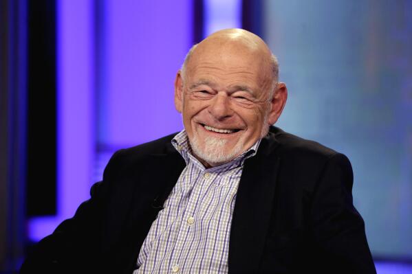 FILE - Sam Zell, chairman of Equity Group Investments, and chairman of Equity International, smiles during an interview by Neil Cavuto, on the Fox Business Network, in New York, on Aug. 6, 2013. Zell, a Chicago real estate magnate who earned a multibillion-dollar fortune and a reputation as "the grave dancer" for his ability to revive moribund properties, died on Thursday, May 18, 2023. He was 81. (AP Photo/Richard Drew, File)