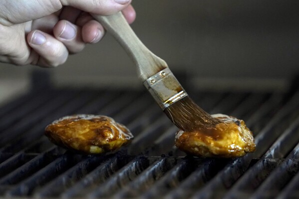 Chef Zach Tyndall prepares Good Meat's cultivated chicken at the Eat Just office in Alameda, Calif., Wednesday, June 14, 2023. The Agriculture Department issued final approvals Wednesday, June 21 to California firms Upside Foods and Good Meat to sell the products, known as “lab grown” or “cultivated” meat. (AP Photo/Jeff Chiu)