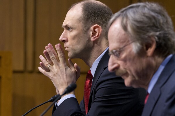 FILE - Austan Goolsbee, left, then Council of Economic Advisers Chairman, testifies on Capitol Hill in Washington on Feb. 28, 2013. Now president of the Federal Reserve Bank of Chicago, Goolsbee said in an interview with The Associated Press that the economy was still on what he calls the "golden path," another term for what economists call a "soft landing," in which inflation returns to the Fed's 2% target without an economic crash. (AP Photo/J. Scott Applewhite, File)