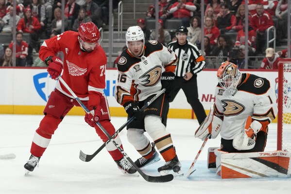 Detroit Red Wings center Dylan Larkin (71) shoots the puck towards Anaheim Ducks goaltender Lukas Dostal (1) during the second period of an NHL hockey game, Monday, Dec. 18, 2023, in Detroit. (AP Photo/Carlos Osorio)
