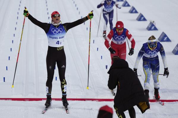 Victoria Carl, of Germany, celebrates a gold medal finish ahead of silver medal finisher Jonna Sundling, of Sweden, right, and bronze medal finisher Natalia Nepryaeva, of the Russian Olympic Committee, during the women's team sprint classic cross-country skiing competition at the 2022 Winter Olympics, Wednesday, Feb. 16, 2022, in Zhangjiakou, China. (AP Photo/Alessandra Tarantino)