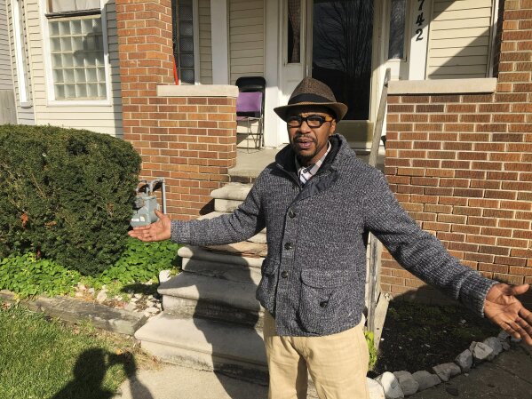 In this Nov. 5, 2019, photo, Charles Jones Jr. stands outside his house in Detroit.  He says he will participate in the census and hopes his neighbors make sure they are counted. “You just can’t walk and knock on somebody’s door, now,” said Jones Jr. “You’ve got to find somebody in the neighborhood that the people trust. Not strangers. They’re scared of strangers.” (AP Photo/Corey Williams)