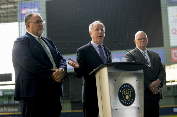 Wisconsin Speaker of the Assembly Robin Vos is flanked by State Rep. Robert Brooks, left, and State Senator Dan Feyen as they unveil a stadium repair funding plan aimed at keeping the Milwaukee Brewers in Milwaukee at a news conference Monday, Sept. 18, 2023, at American Family Field in Milwaukee. (AP Photo/Morry Gash)