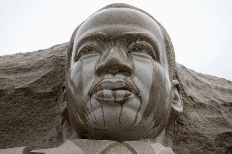 FILE - Rain runs down the face of the Martin Luther King Jr. Memorial in Washington, Tuesday, Aug. 13, 2013. (AP Photo/Carolyn Kaster, File)