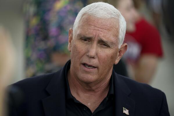 Former Vice President Mike Pence speaks to reporters during a visit to the Iowa State Fair, Friday, Aug. 19, 2022, in Des Moines, Iowa. (AP Photo/Charlie Neibergall)