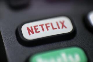 This Aug. 13, 2020, photo shows a logo for Netflix on a remote control in Portland, Ore. Netflix reported its worst slowdown in subscriber growth in eight years as people emerge from their pandemic cocoons. But it has an answer to that: Video games. On Tuesday, July 20, 2021 the streaming giant announced plans to begin adding video games to its existing subscription plans at no extra cost. The confirmation of the long-anticipated expansion came in conjunction with the release of its latest earnings report. (AP Photo/Jenny Kane)