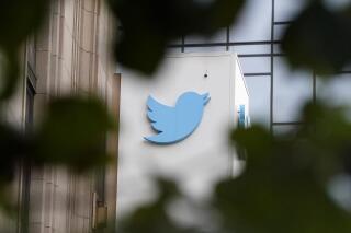 FILE - A sign at Twitter headquarters is shown in San Francisco, on Dec. 8, 2022. Sweden’s public radio said Tuesday April 18, 2023 that it would stop being active on Twitter, but it did not blame new labels that Elon Musk’s social media platform has slapped on public broadcasters and led major North American outlets to quit tweeting.(AP Photo/Jeff Chiu, File)