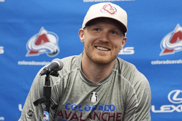Injured Colorado Avalanche captain Gabriel Landeskog, of Sweden, jokes with reporters during a news conference at the NHL hockey team's training headquarters Thursday, May 23, 2024, in Centennial, Colo. (AP Photo/David Zalubowski)