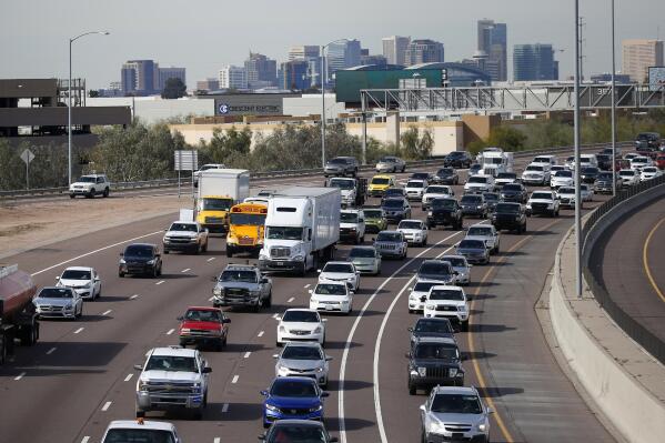 FILE - In this Jan. 24, 2020 file photo, early rush hour traffic rolls along I-10 in Phoenix.  Searching for a vehicle recall just got a little more user-friendly. The National Highway Traffic Safety Administration on Thursday, July 1, 2021 unveiled a new online dashboard for vehicle owners, car shoppers, or anyone else to search its massive database for automobile recalls going back 50 years.  (AP Photo/Ross D. Franklin, File)