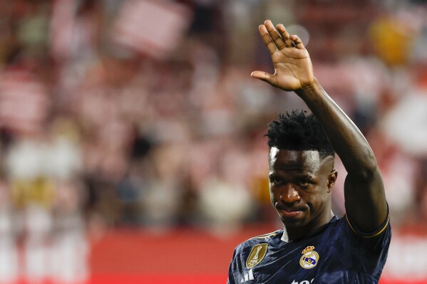 Real Madrid's Vinicius Junior greets fans at the end of the a Spanish La Liga soccer match between Girona and Real Madrid, at the Montilivi stadium in Girona, Spain, Saturday, Sept. 30, 2023. (AP Photo/Joan Monfort)