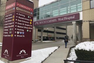 FILE - In this Jan. 15, 2019 file photo, the main entrance to Mount Carmel West Hospital is shown in Columbus, Ohio.  The Ohio hospital system investigating a doctor accused of ordering painkiller overdoses for dozens of patients says five who died may have received excessive doses when there still was a chance to improve their conditions with treatment. The Columbus-area Mount Carmel Health System said Friday, Feb. 22  it's notifying those patients' families.  (AP Photo/Andrew Welsh Huggins, File)