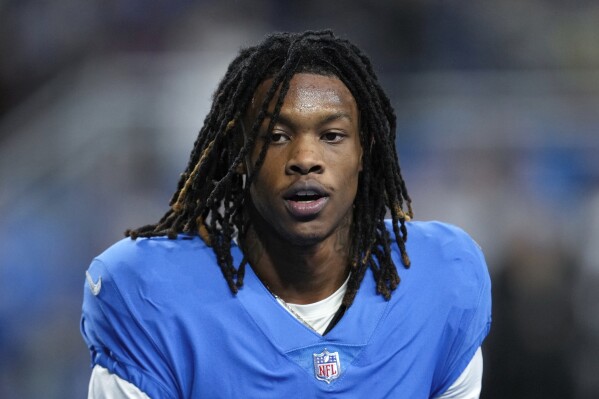 FILE - Detroit Lions wide receiver Jameson Williams watches during an NFL football game against the Chicago Bears in Detroit, Jan. 1, 2023. The NFL has revised its gambling policy and is reinstating three players who previously received longer suspensions. Tennessee's Nicholas Petit-Frere and Detroit's Jameson Williams can return to their teams on Monday, Oct. 2. Free agent Stanley Berryhill will be eligible to participate in all activities, including games, starting Tuesday, Oct. 3. All three players were initially suspended six games.(AP Photo/Paul Sancya, File)