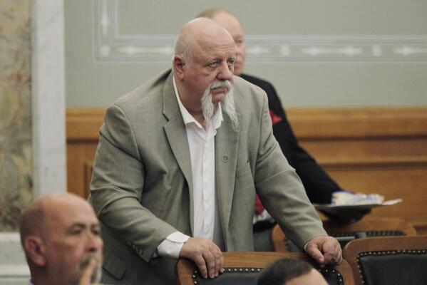 Kansas state Rep. Michael Houser, R-Columbus, follows speeches by House leaders praising their staff just before the House adjourns for the year, Friday, April 28, 2023, at the Statehouse in Topeka, Kan. No big tax cuts are coming for Kansas residents even though the state treasury is bulging with surplus cash. (AP Photo/John Hanna)